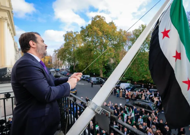 Foreign Minister and Expatriates  al-Shaibani Raises The flag of The Syrian Arab Republic above The Syrian Embassy Building in The British Capital, London